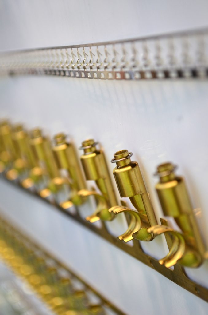 photo of brass components lined up on a shelf